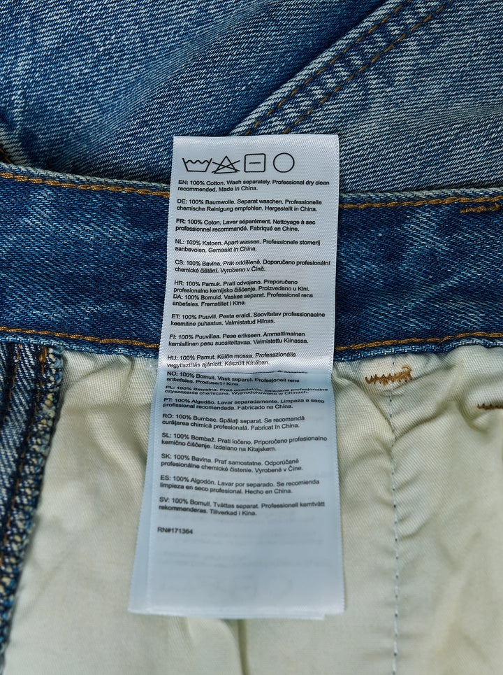 KidSuper Studios Eye Badge washed double knee jeans in faded blue denim with contrast topstitching and utility hammer loop, front view - view 5