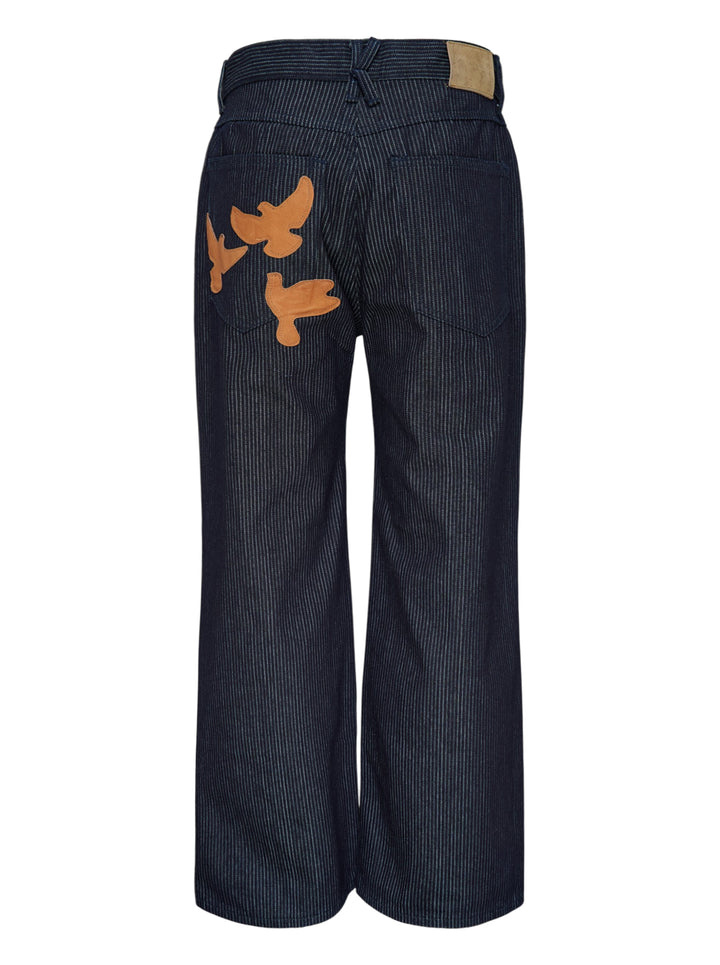 KidSuper Studios Stripe Dove Denim Pants in dark indigo with fine vertical pinstripes, a ridged waistband and a wide-leg cut, shown from the front - view 2