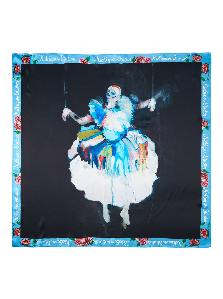 KidSuper Studios Puppet Master silk scarf featuring a painted marionette ballerina in a white and blue tutu on a black ground, framed by a blue border of red roses and script lettering
