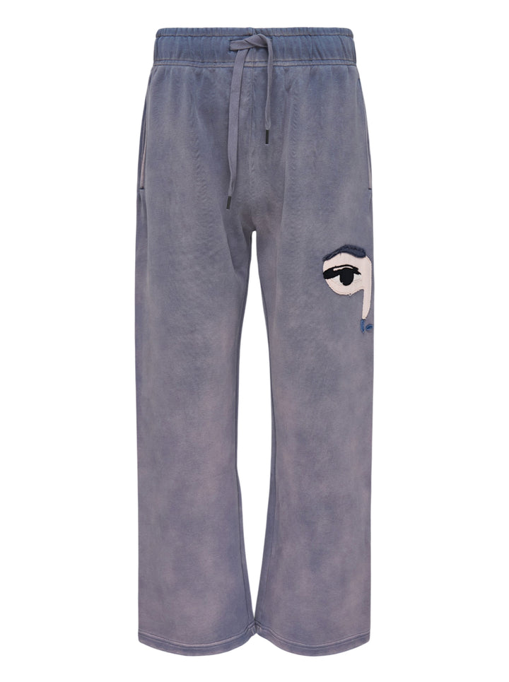 KidSuper Studios Face Sweatpants in washed lavender-grey with an appliqué eye patch and drawstring waist