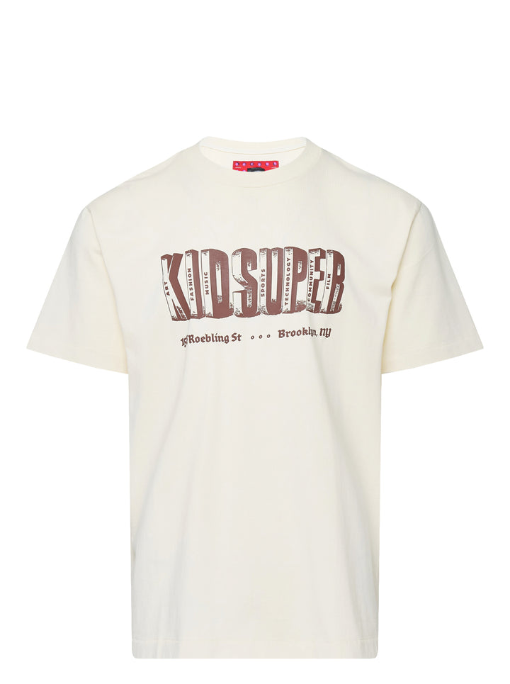 KidSuper Studios Block Letters Tee in cream with brown dimensional block-letter logo and Brooklyn, NY address print on the chest