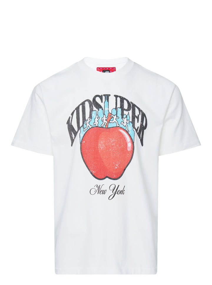 White KidSuper Studios short sleeve tee with a distressed red apple graphic, blue New York skyline, running figures and New York script lettering