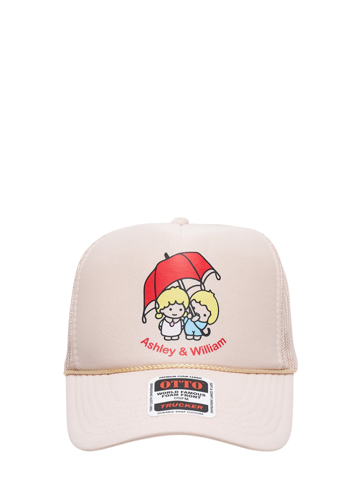 Ashley Williams cream foam-front trucker hat with Ashley & William cartoon characters under a red umbrella graphic, gold braid trim at brim and mesh back panel