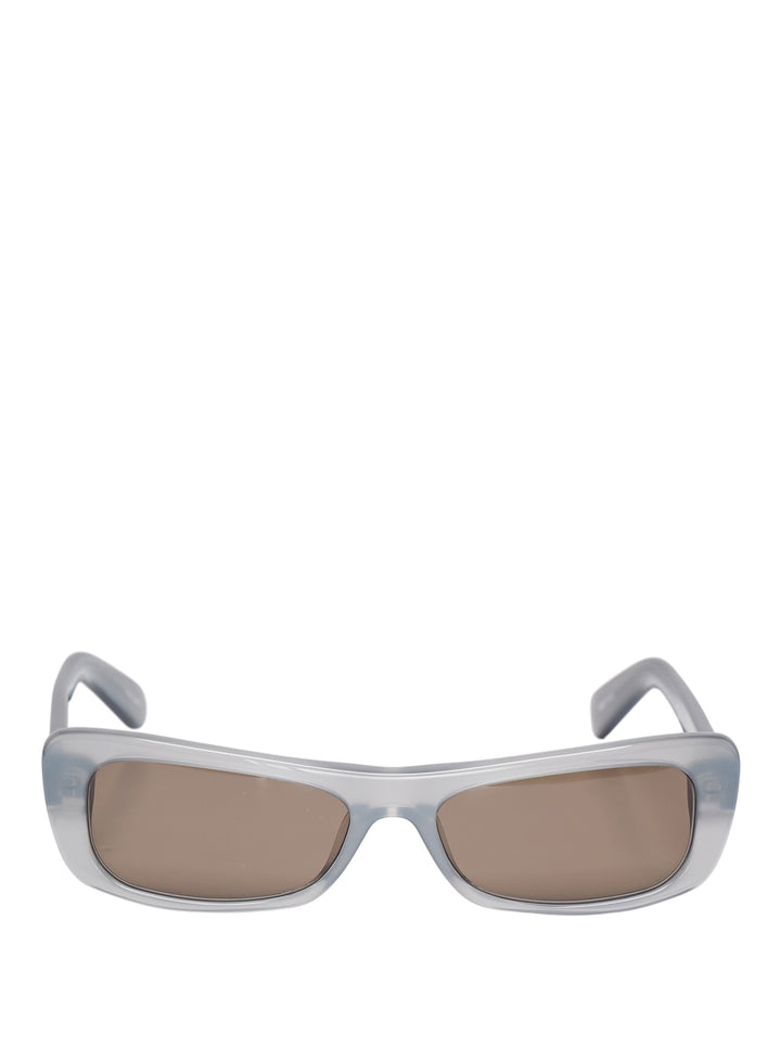 Jacquemus Capri rectangular sunglasses with a translucent pale blue-grey frame and brown tinted lenses, front view