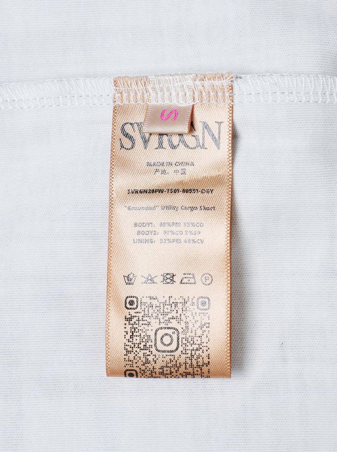 Sultry Virgin Utility Cargo Skort in grey suiting fabric, featuring a crossover wrap waistband with snap buttons, layered pleated panels, cargo pocket detailing, and a plaid underlay at the hem - view 3