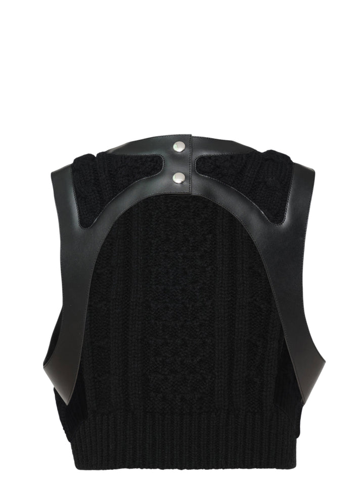 Noir Kei Ninomiya black cable-knit sleeveless vest with structured leather yoke, cutout detailing, and silver press-stud fastening at the rear neckline - view 2
