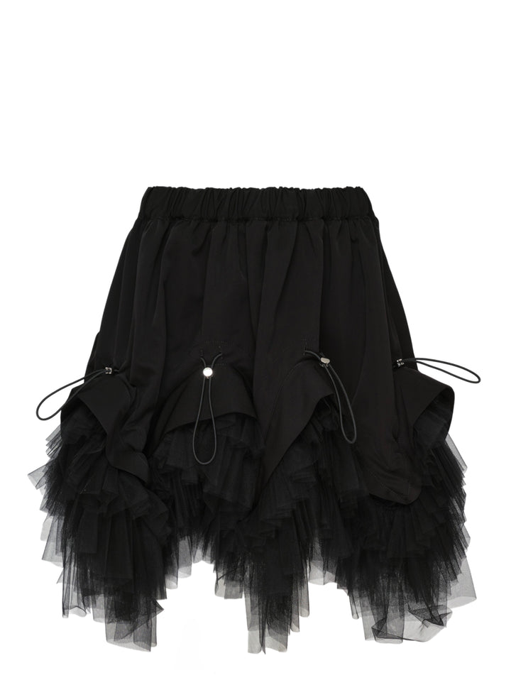 Noir Kei Ninomiya black elasticated waistband mini skirt with ruched woven panels, adjustable drawstring toggles, and layered tiered tulle hem, photographed flat on white background