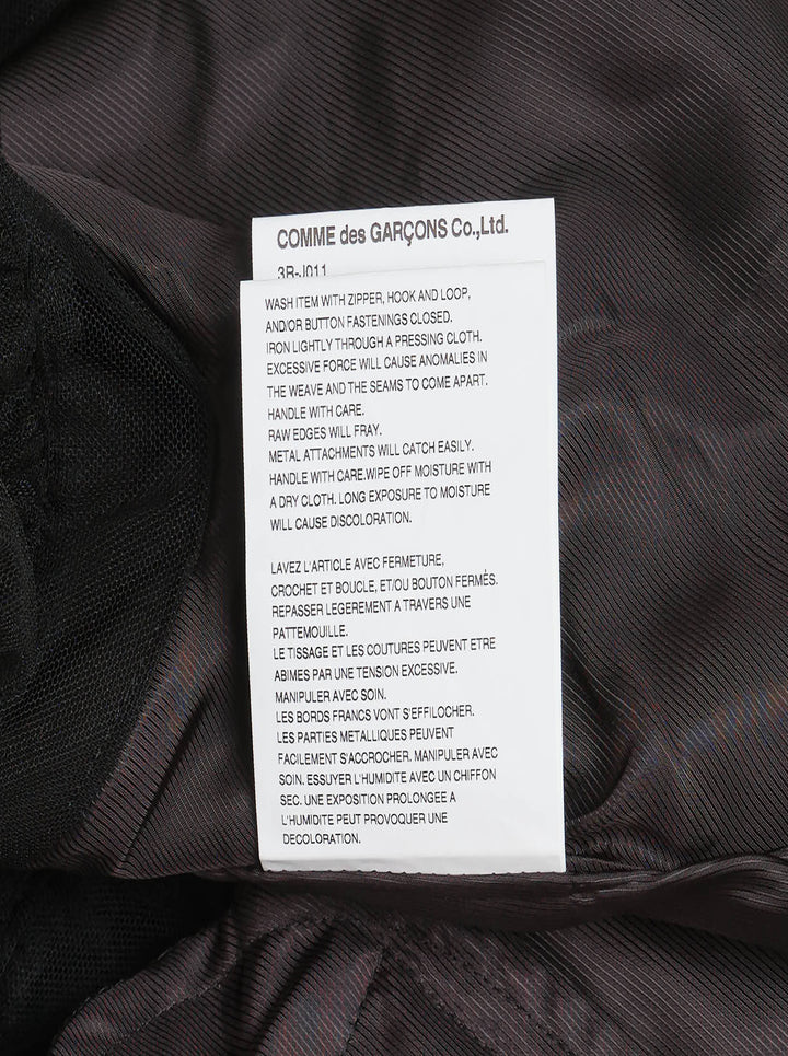 Noir Kei Ninomiya black asymmetrical midi skirt with tiered tulle ruffles and elasticated waistband, shown flat on white background - view 4