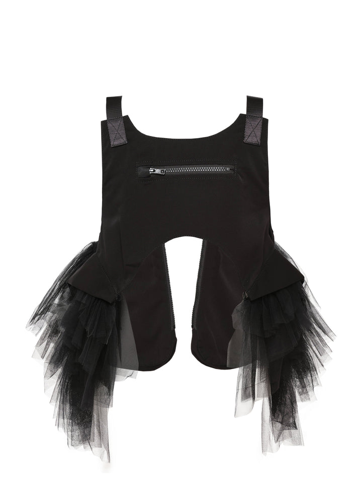 Noir Kei Ninomiya black harness vest with diagonal zip pockets, clip-buckle webbing straps, and cascading sheer tulle panels at the sides, photographed flat on a white background - view 2