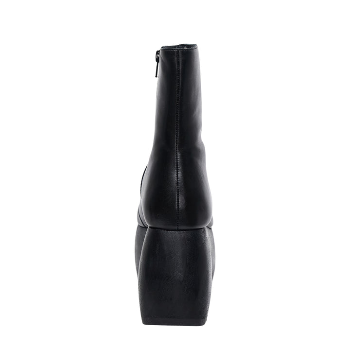 Comme des Garçons x John Fluevog black leather platform ankle boot with sculptural carved heel block and rounded square toe, side profile view
