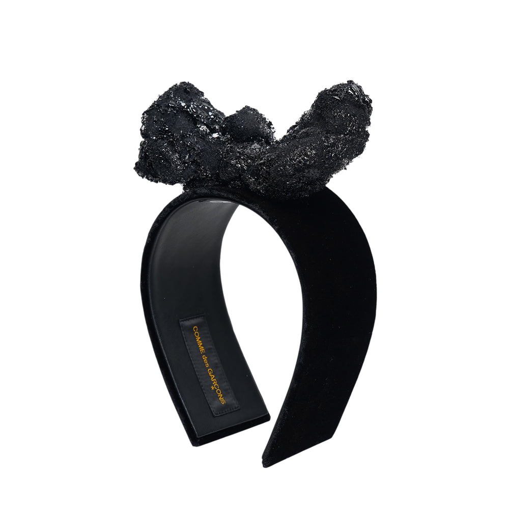 Comme des Garçons x HIZUME black velvet headband with an oversized sculptural beaded and sequined bow embellishment, shown on a white background
