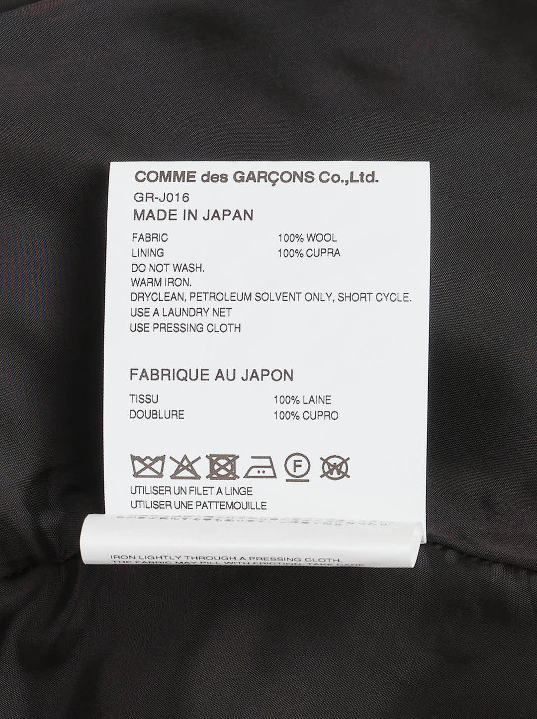 Comme des Garçons black sculptural asymmetric blazer with deconstructed layered lapels, mother-of-pearl buttons, and asymmetric hem revealing satin lining, photographed flat on white background - view 3