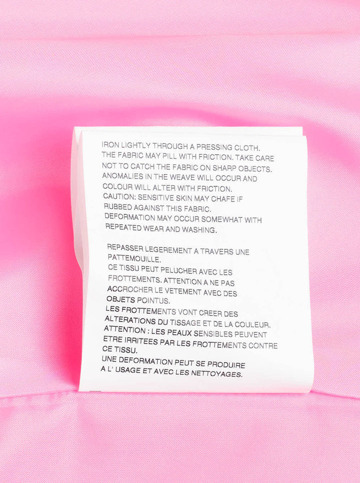 Comme des Garçons hot pink satin single-breasted blazer with large cascading gathered ruffle appliqués across the front, four cream buttons, and a notched lapel, product flat lay on white background - view 4