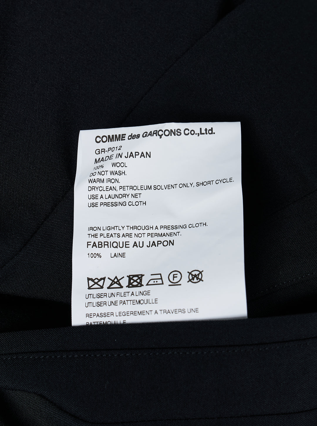 Comme des Garçons black pleated wide-leg trousers with elasticated waistband and fluid, midi-length silhouette, displayed flat on a white background - view 3