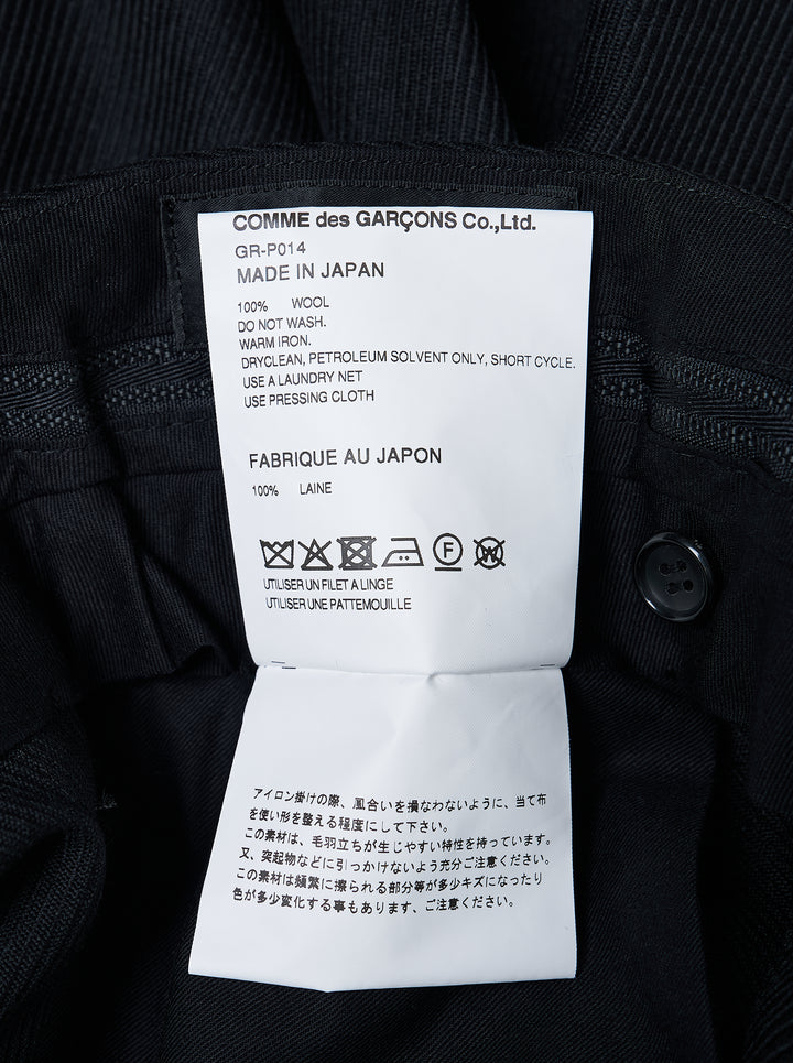Comme des Garçons black balloon trousers with pleated high waist, voluminous silhouette, and elasticated gathered hems, shot flat on white background - view 3