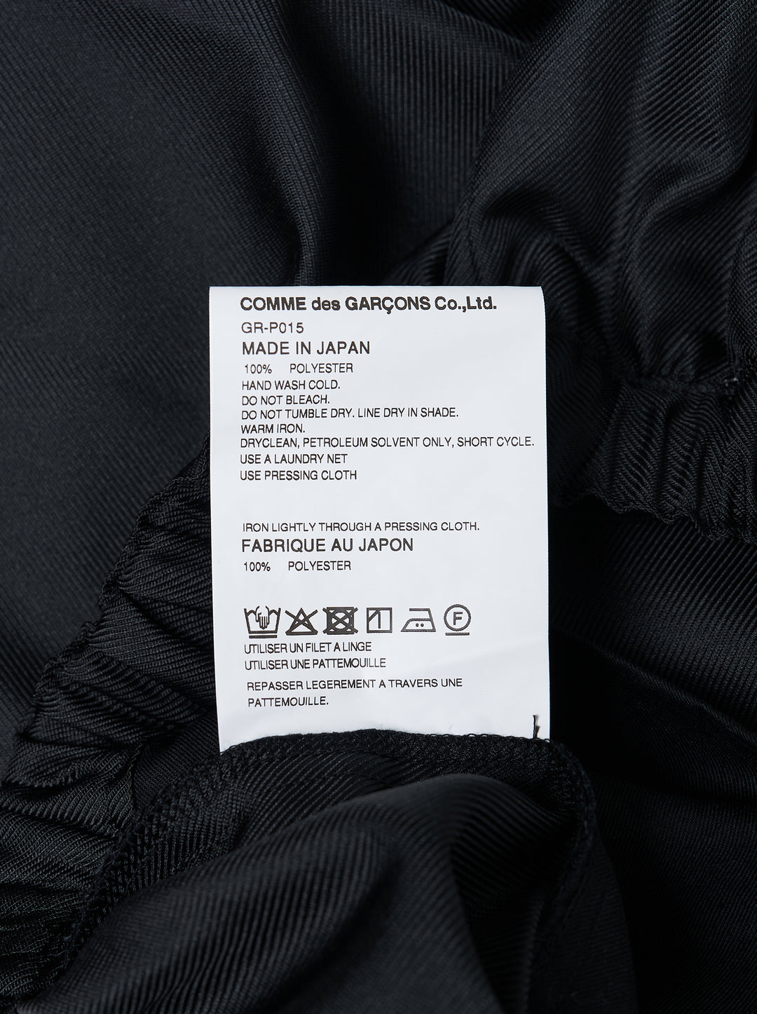 Comme des Garçons wide-leg black pants with dramatic ruched frill panels along both side seams and an elasticated waistband, displayed flat against a white background - view 3