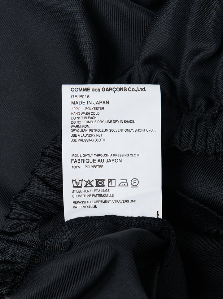 Comme des Garçons wide-leg black pants with dramatic ruched frill panels along both side seams and an elasticated waistband, displayed flat against a white background - view 3