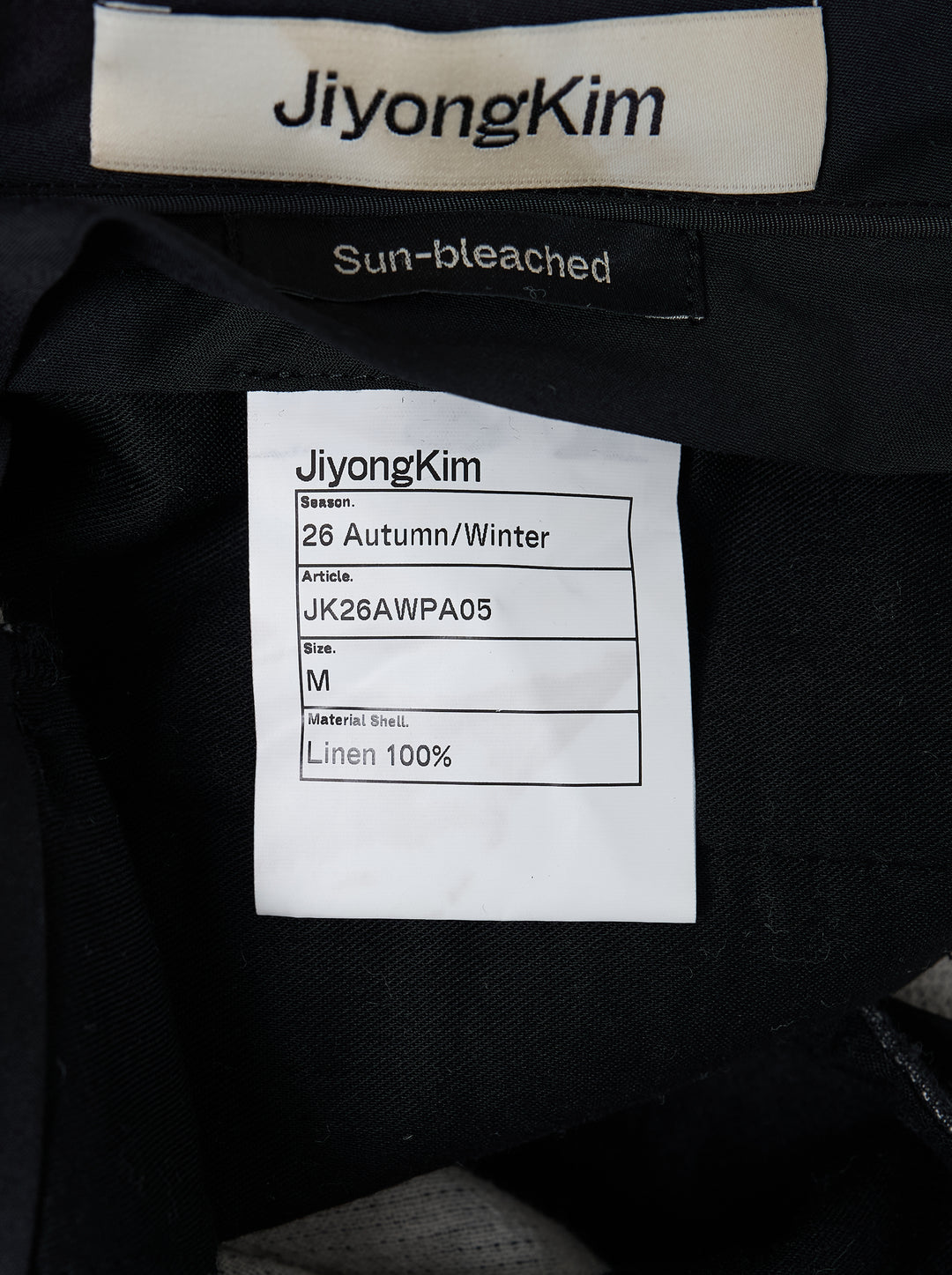 JiyongKim sun-bleached wide-leg trousers in faded charcoal with oversized 3D cargo pockets and a frayed waistband, front view - view 3
