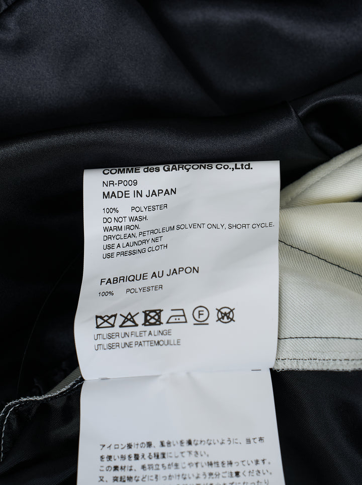 Comme des Garçons Girl black satin shorts with elasticated ruched waistband, gathered silhouette, and tiered ruffle hem, shot flat on a white background - view 3