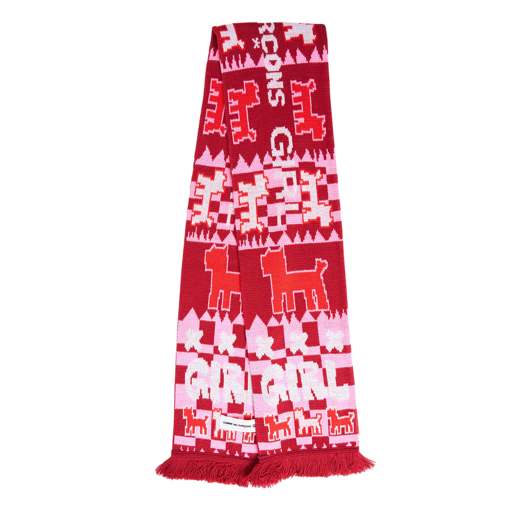 Comme des Garçons Girl holiday knitted acrylic stole with all-over reindeer and tree jacquard motifs in red, pink, and white, with fringe trim at both ends