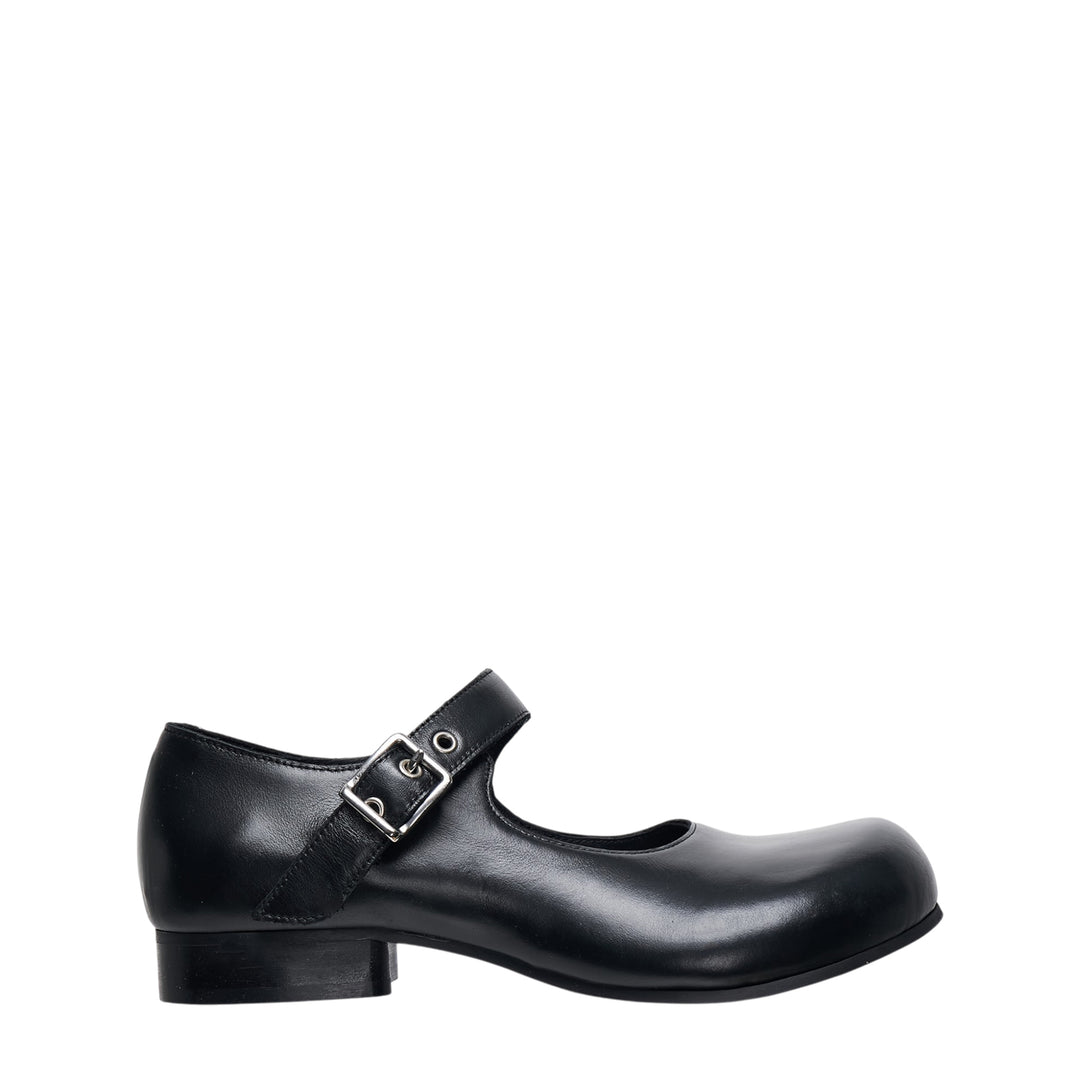 Comme des Garçons Comme des Garçons black leather Mary Jane flat with sculptural round toe and silver buckle instep strap, side profile view