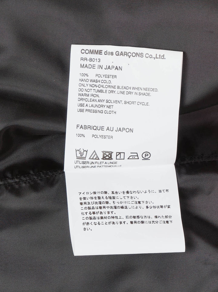 Comme des Garçons Comme des Garçons black satin blouse with dramatic tiered gathered ruffle bib front, long sleeves, point collar, and button fastening, on a white background - view 3