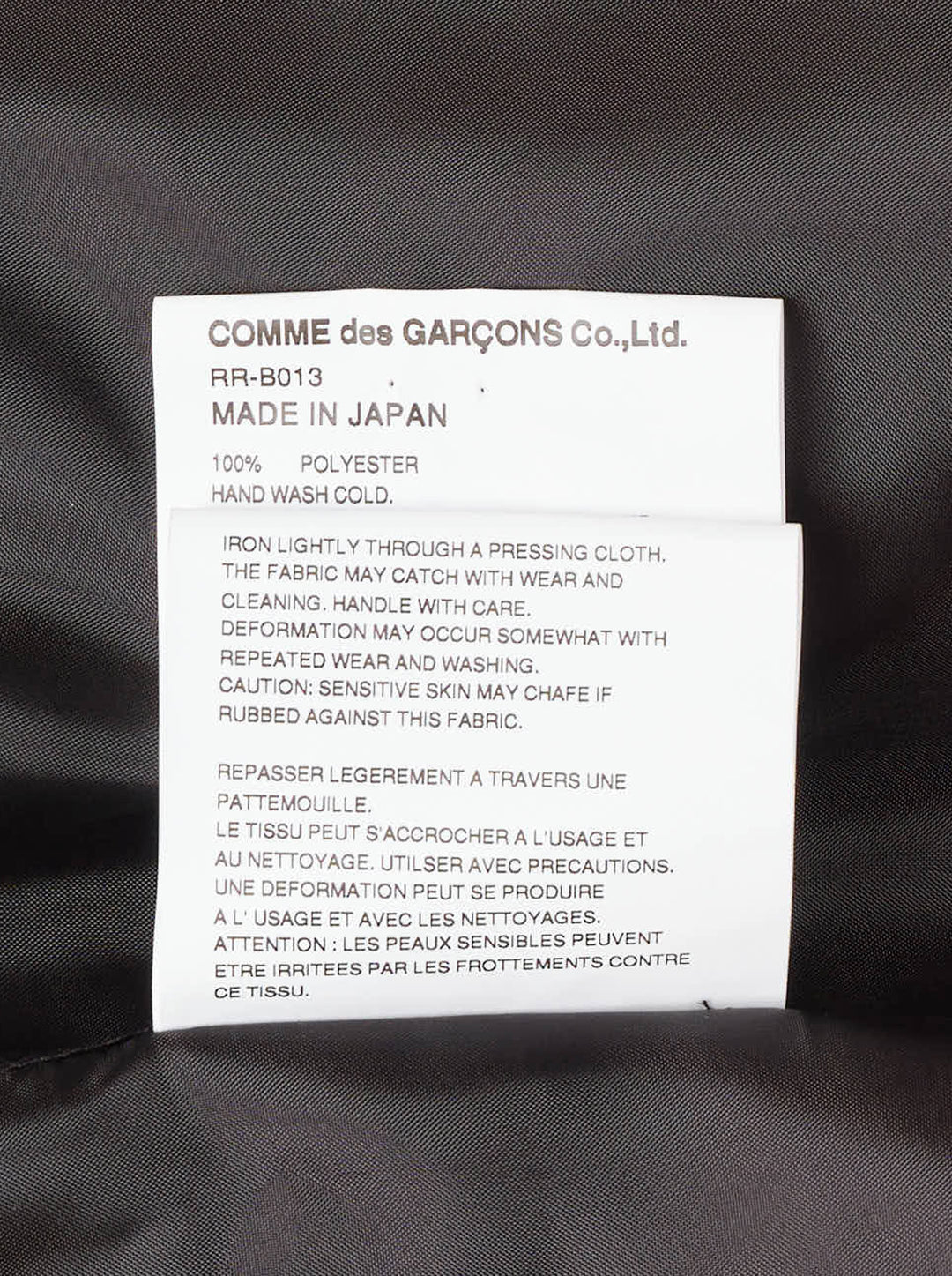 Comme des Garçons Comme des Garçons black satin blouse with dramatic tiered gathered ruffle bib front, long sleeves, point collar, and button fastening, on a white background - view 4