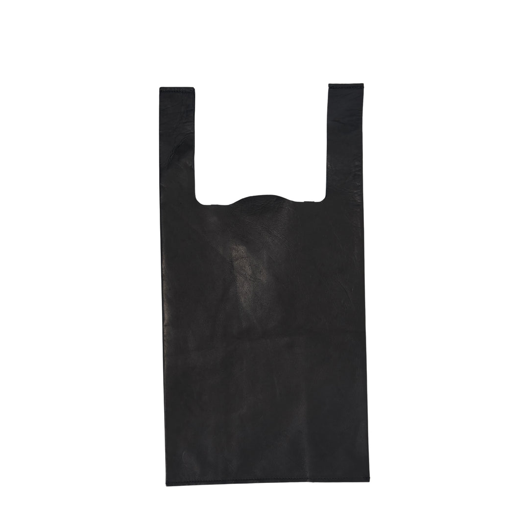Comme des Garçons Comme des Garçons small straight-cut black leather tote bag with wide handles and logo print at base, flat lay on white background