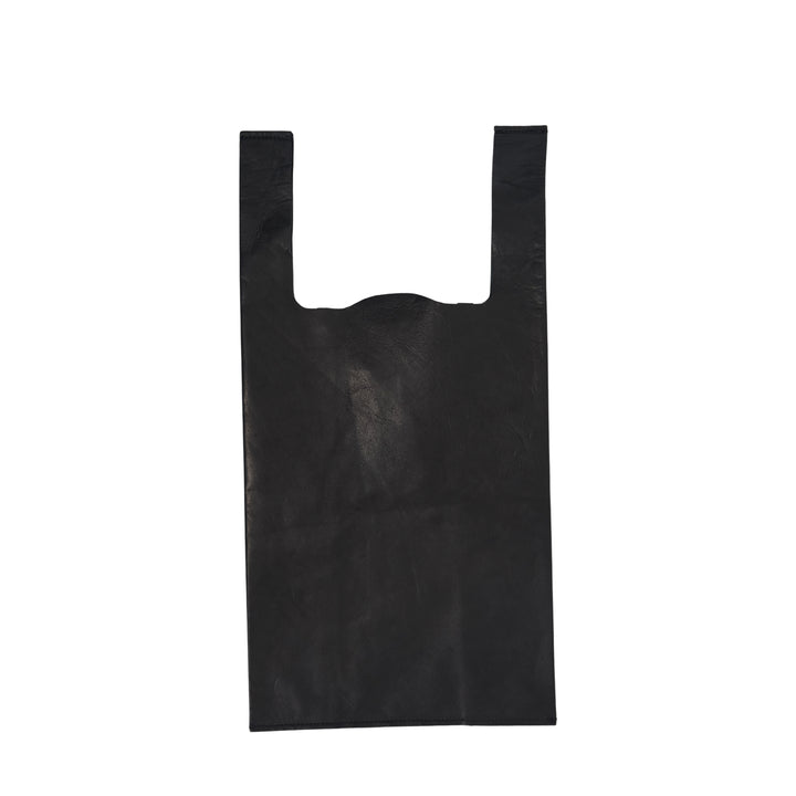 Comme des Garçons Comme des Garçons small straight-cut black leather tote bag with wide handles and logo print at base, flat lay on white background
