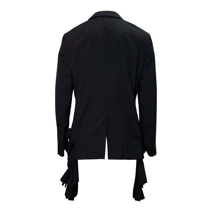 Comme des Garçons Homme Plus black tropical wool single-breasted jacket with gathered fabric loop appliqués across the body and cascading deconstructed strip detailing at the hem, front view on white background - view 2