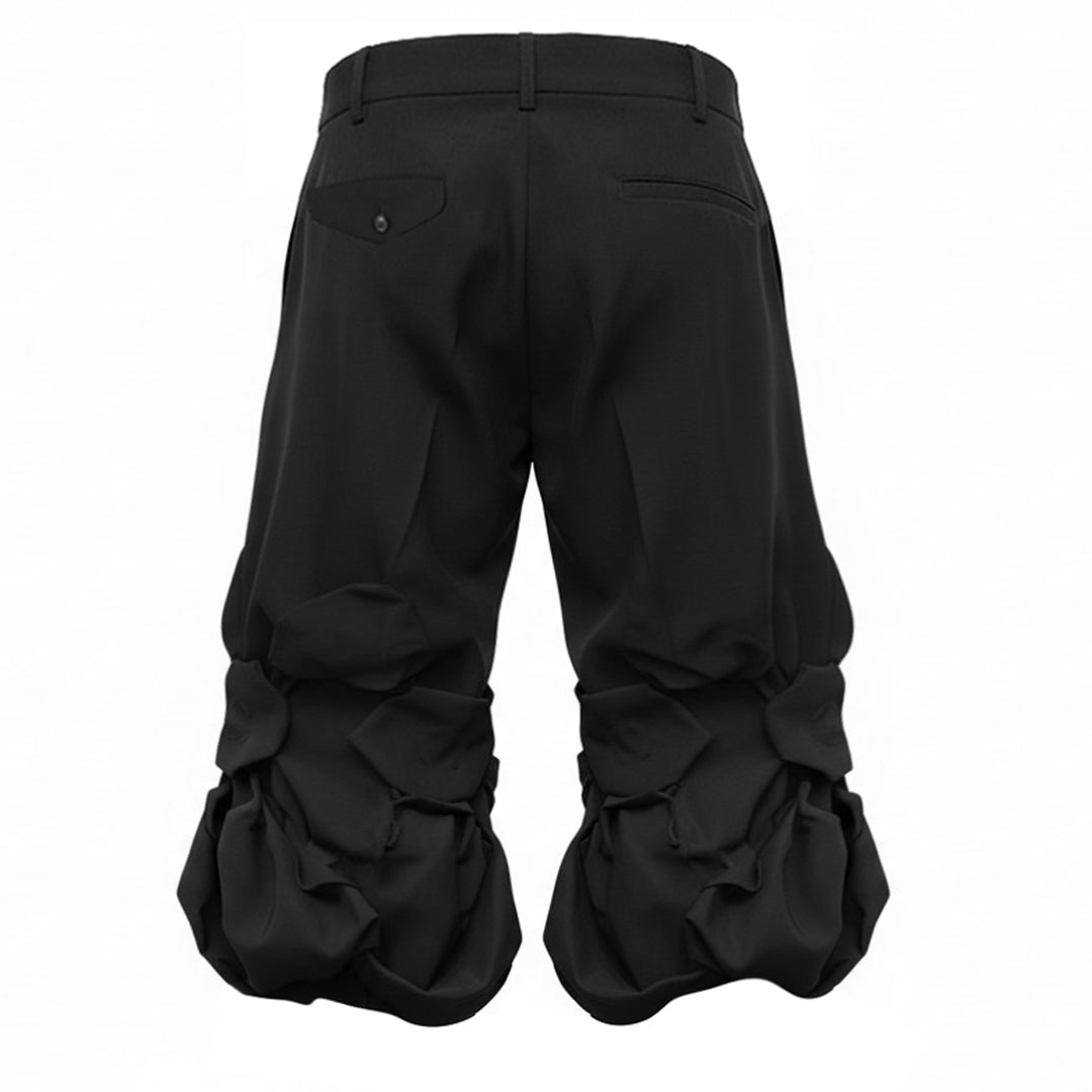 Comme des Garçons Homme Plus black wool tropical shorts with knotted fabric floral clusters and voluminous ruffled hem, front view on white background - view 2