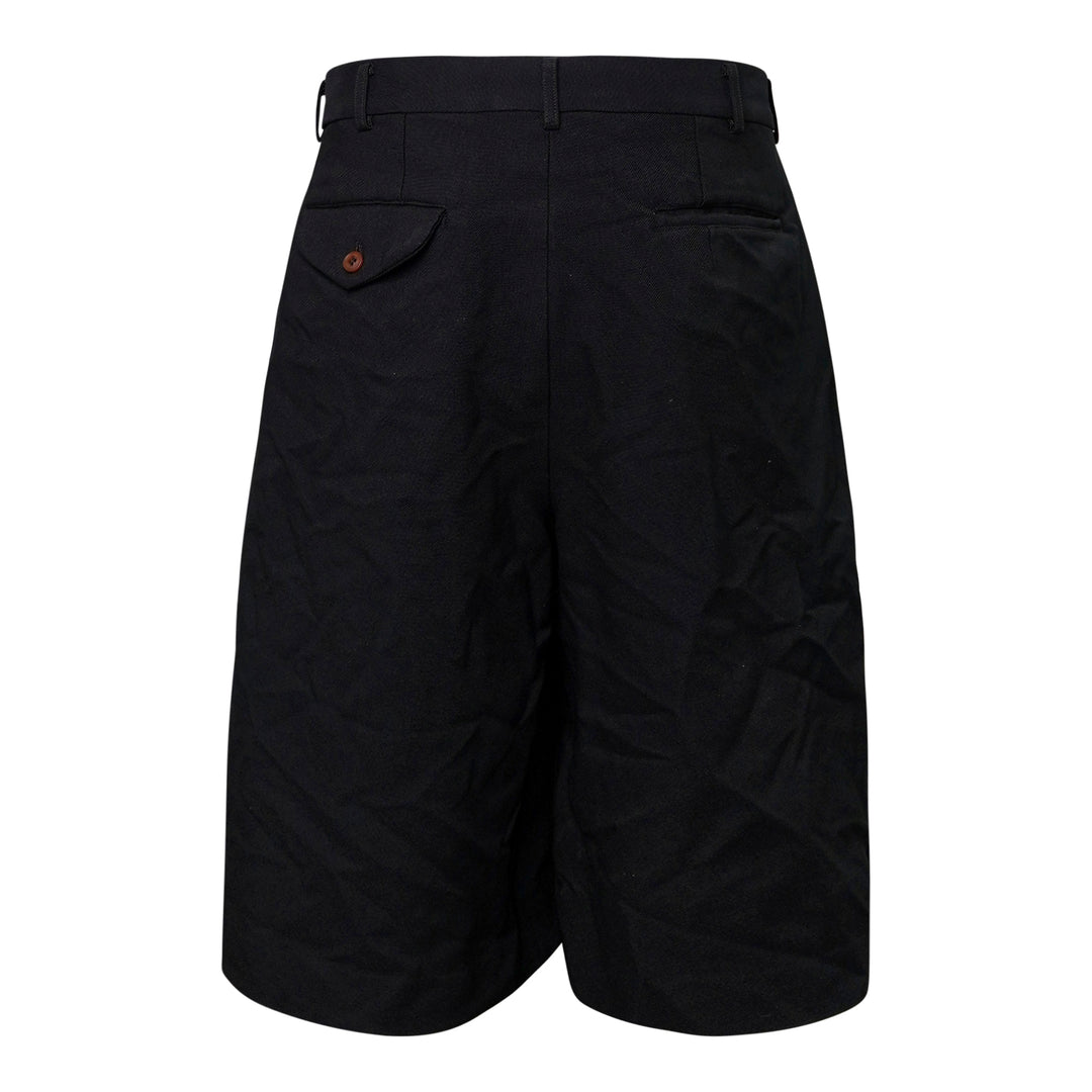 Comme des Garçons Homme Plus garment-dyed black polyester serge shorts with dramatic ruched ruffle detailing and structured waistband, front view - view 2