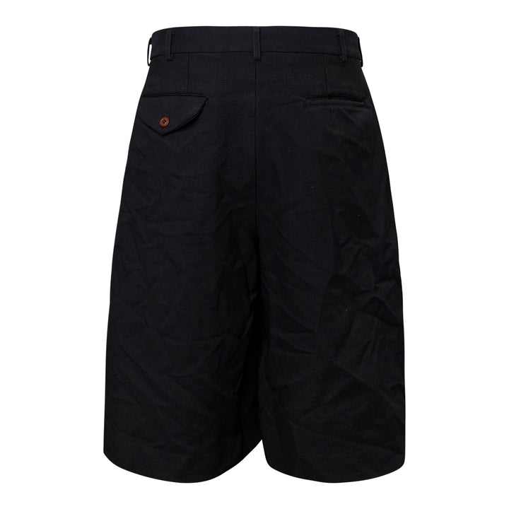 Comme des Garçons Homme Plus garment-dyed black polyester serge shorts with dramatic ruched ruffle detailing and structured waistband, front view - view 2