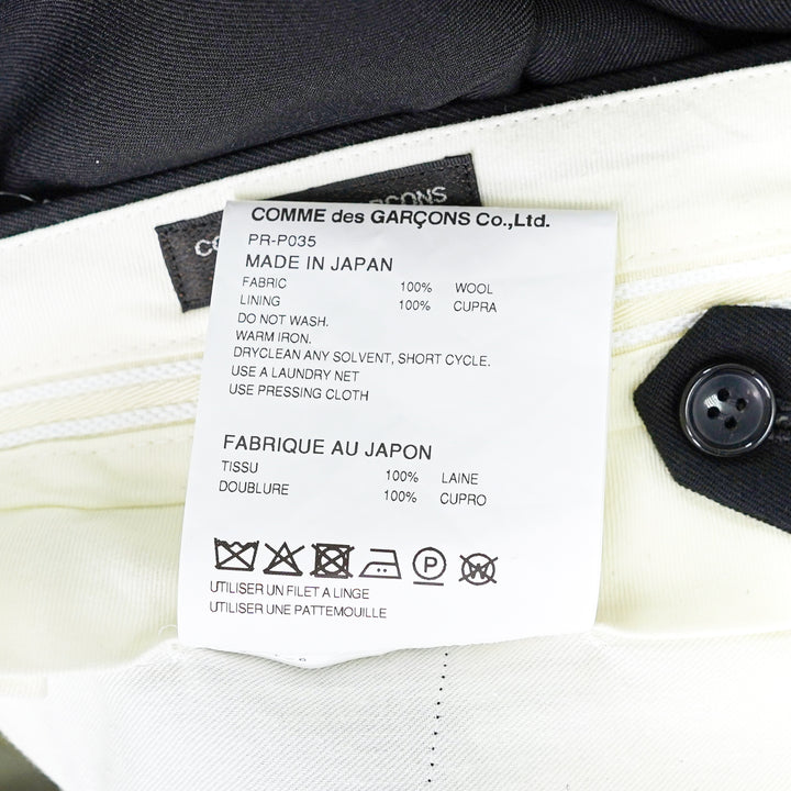 Comme des Garçons Homme Plus wool gabardine double-pleat high-rise tapered trousers in dark charcoal, flat lay on white background - view 3
