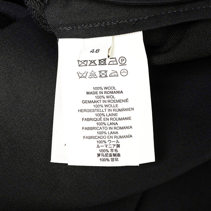Dries Van Noten black pleated wrap kilt skirt with diagonal buckle waistband and asymmetric knife-pleated hem, shot on a white background - view 3