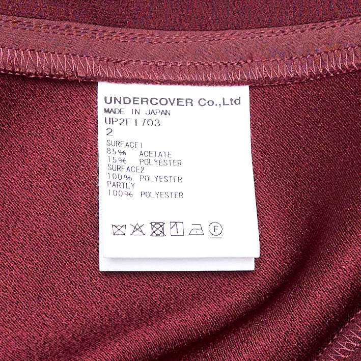 Undercover Layered Effect Midi Dress in deep burgundy, featuring a V-shaped satin chest panel, short sleeves, and sheer chiffon overlay panels falling to an asymmetric handkerchief hem