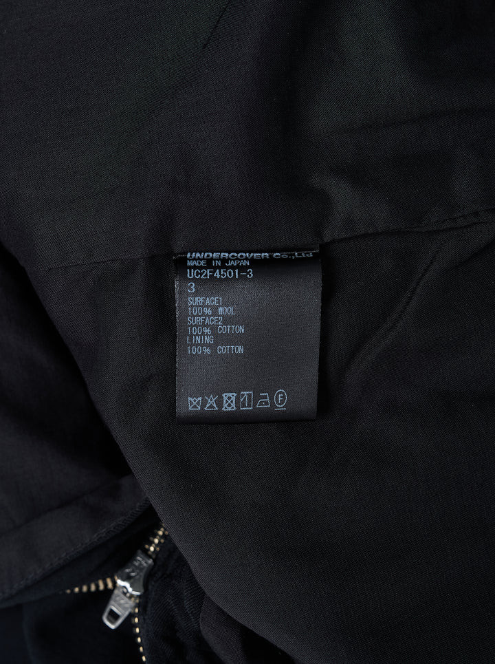 Undercover black stripe wool pants with tonal pinstripe texture, button waistband and straight leg, shown front view - view 3