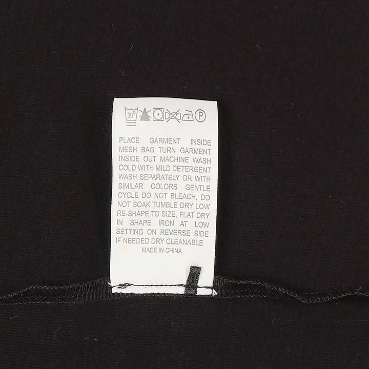 Club21 Collection black long sleeve Henley knit top with tonal button placket and ribbed crew neckline, displayed on a ghost mannequin against a white background