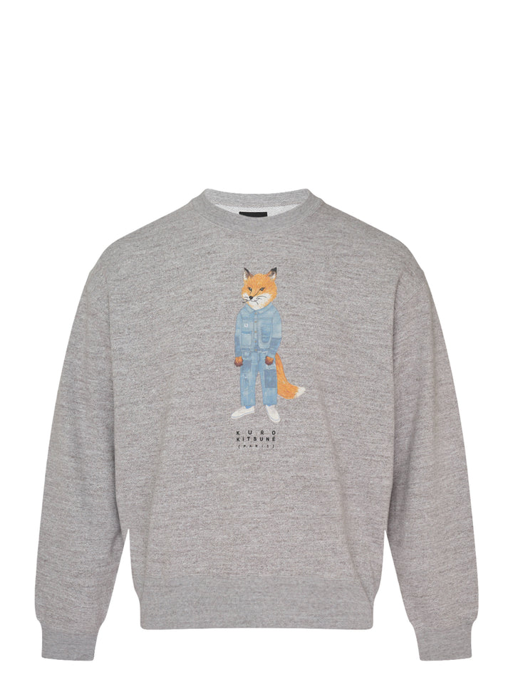 Grey marl crewneck sweatshirt with an illustrated fox in a patchwork denim jacket and jeans and Kuro Kitsuné Paris lettering on the chest