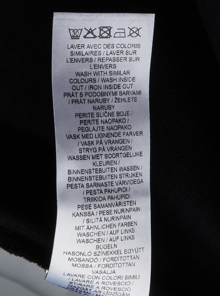 Maison Kitsuné Handwriting Oversized Tee in black with embroidered white script logo on the chest, front view - view 3