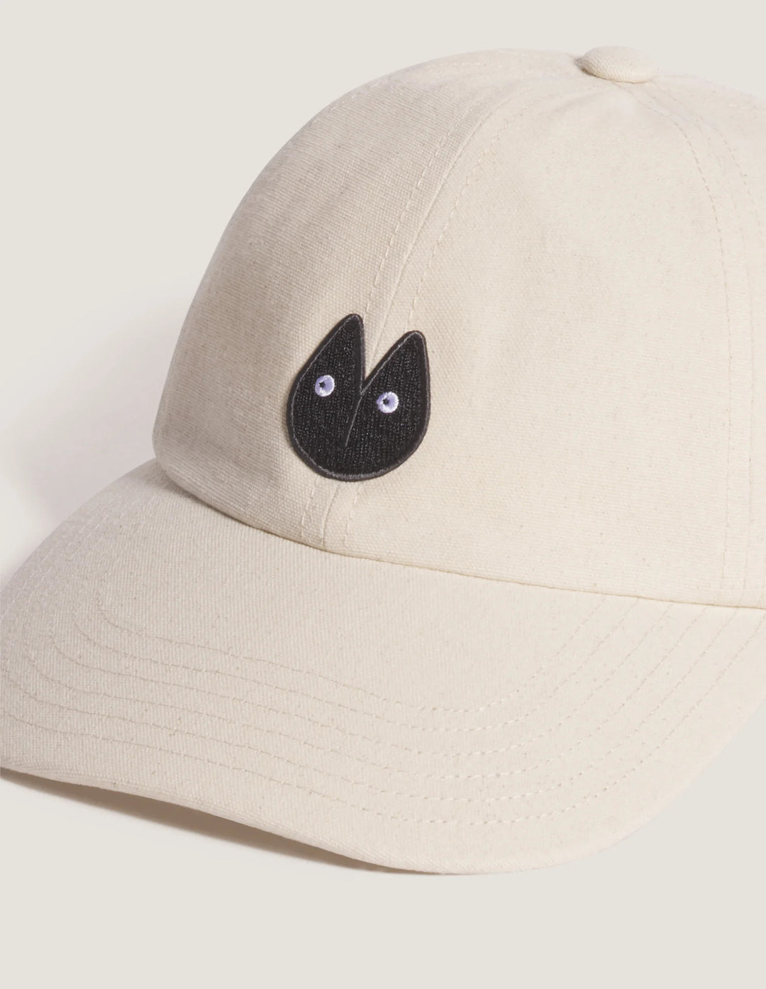 Maison Kitsuné Fortune Fox Cap in cream with an embroidered black fox head patch on the front and a curved brim - view 3
