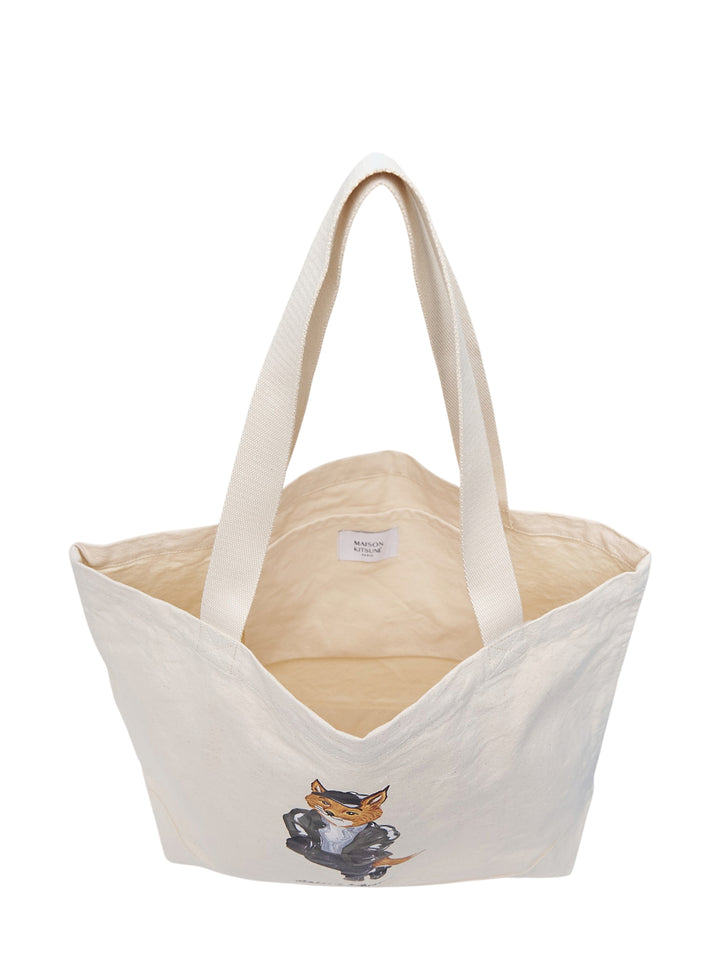 Maison Kitsuné Weekend Fox natural canvas tote bag with illustrated fox wearing a cap, utility jacket and jeans above the handwritten Paris logo - view 3