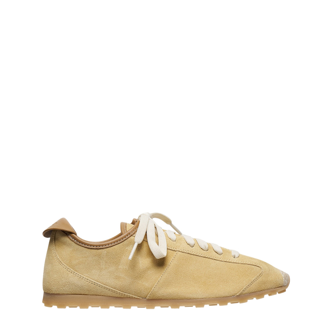 Jacquemus Les Tennis suede sneaker in sandy beige with cream flat laces, leather heel tab, and a gum rubber outsole, shown in profile