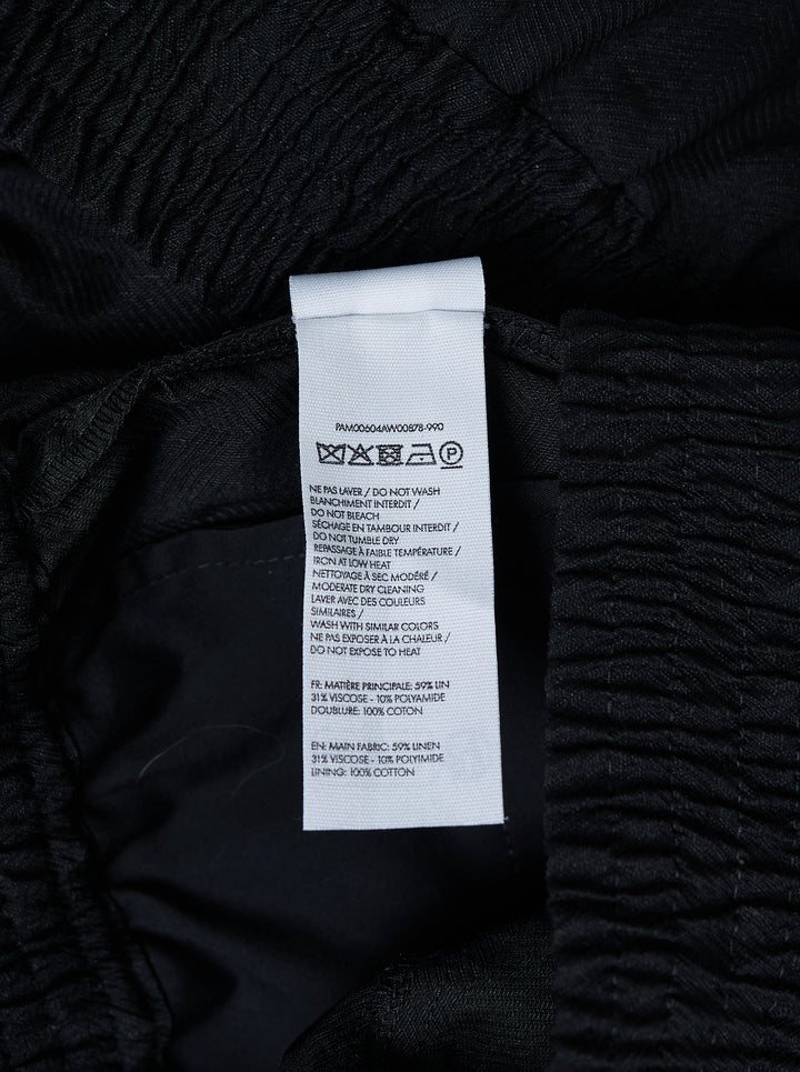 Jacquemus Le Pantalon Miami black wide-leg trousers with smocked elasticated waistband and pressed centre crease, front view - view 3