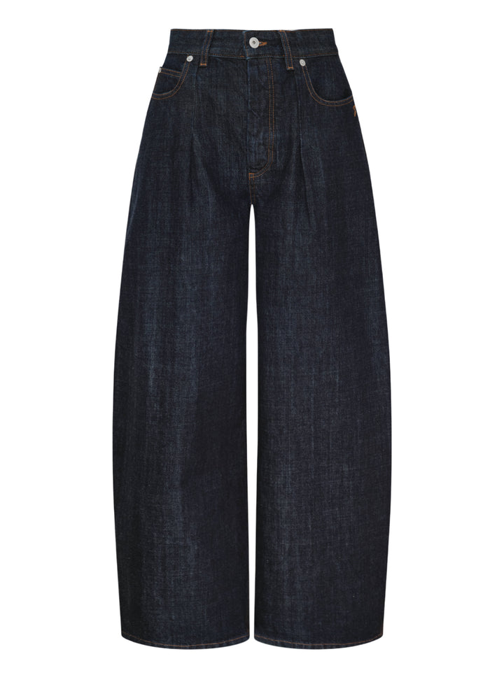 Jacquemus Le De-Nîmes Ovalo jeans in dark indigo denim with a curved barrel leg, front pleats and contrast topstitching