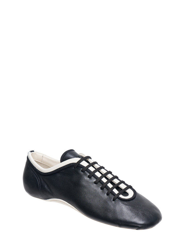 Dries Van Noten foot-shaped black leather lace-up flat shoe with white rubber sole and contrast white collar trim, side profile view - view 2