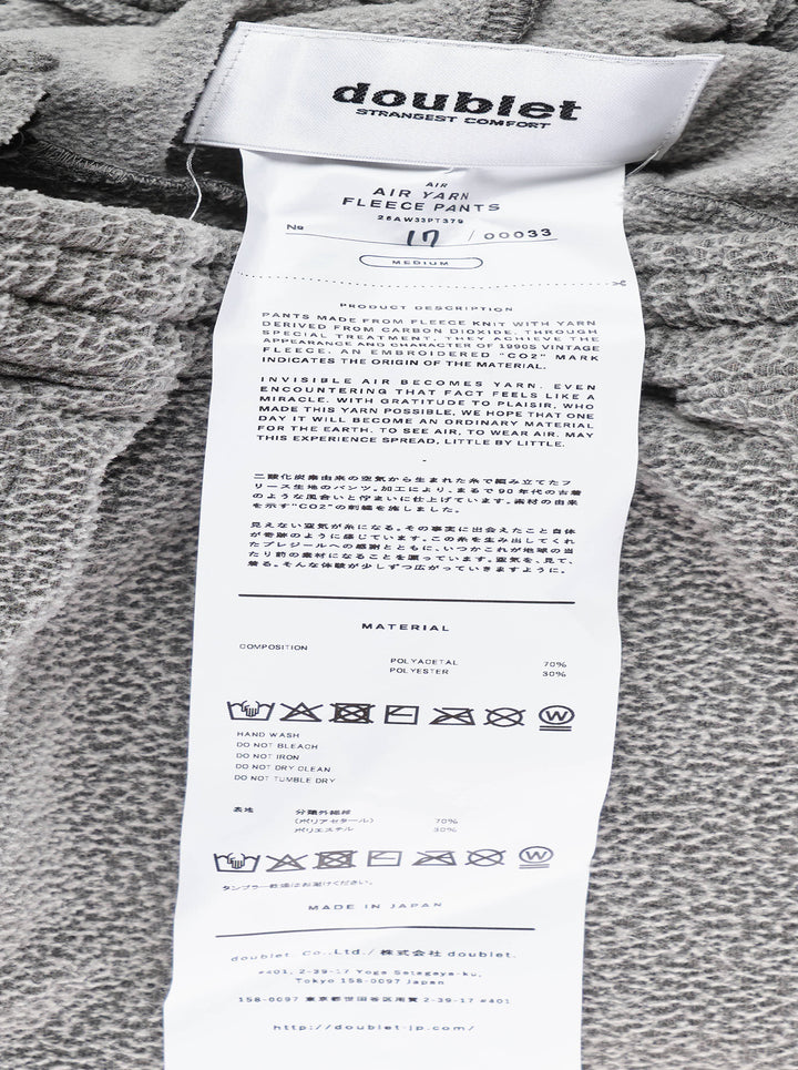 doublet Air Yarn Fleece Pants in heathered grey, featuring a wide-leg silhouette, elasticated drawstring waistband, zip side pockets, and a triangle logo patch at the hip - view 5