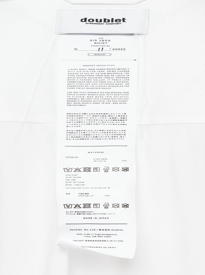 doublet Air Yarn Long Sleeve Shirt in white with embroidered CO2 Zephyr patch on the chest and repeated CO2 stamp graphic on the lower front, shown flat on a white background - view 5