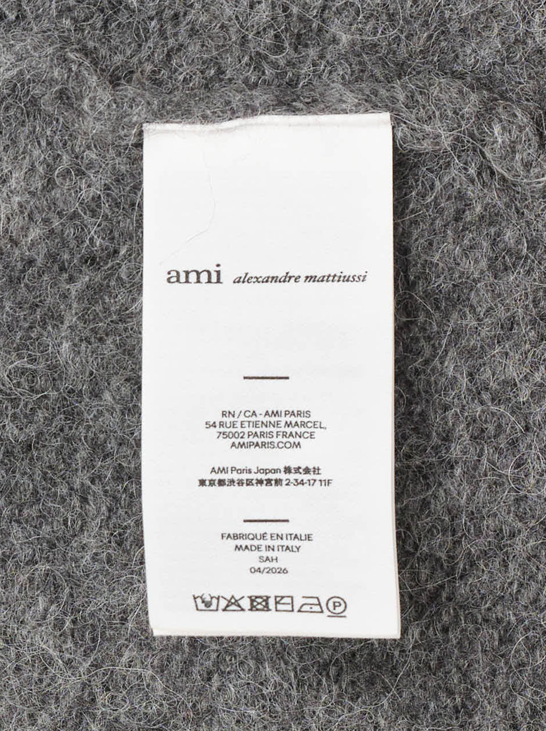 AMI grey bouclé knit polo sweater with spread collar, three-button placket, and ribbed cuffs, displayed on a flat ghost mannequin - view 3