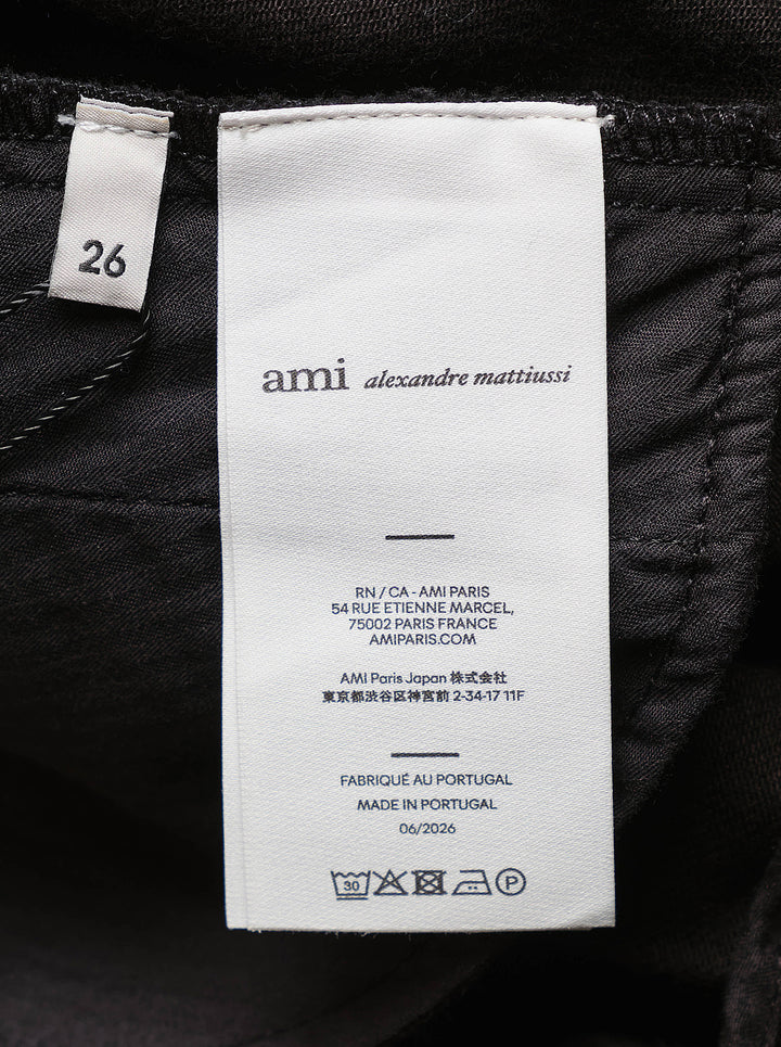 AMI black midi godet skirt with flared paneled silhouette and asymmetric hem, shown from the front - view 3